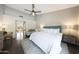 Bright bedroom with a ceiling fan, area rug, desk and an adjacent sitting area at 6101 W Grandview Rd, Glendale, AZ 85306