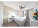 Bright bedroom featuring a large bed, ceiling fan, and natural light at 6101 W Grandview Rd, Glendale, AZ 85306