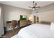 Bright bedroom boasts a vaulted ceiling with fan, desk, dresser with tv, and sitting area at 6101 W Grandview Rd, Glendale, AZ 85306