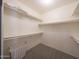 Walk-in closet featuring carpeted floors and white shelving and railings at 6101 W Grandview Rd, Glendale, AZ 85306