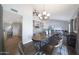 Dining room with hardwood floors, tall ceilings, and views of the stairs and game room at 6101 W Grandview Rd, Glendale, AZ 85306