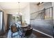 Open-concept dining room featuring a chandelier, stylish chairs, and staircase, filled with natural light at 6101 W Grandview Rd, Glendale, AZ 85306