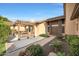 Welcoming front entrance with beautiful landscaping and a cozy covered seating area at 6101 W Grandview Rd, Glendale, AZ 85306