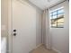 Clean entry with white door, black hardware, small window with curtain, and neutral wall paint at 6101 W Grandview Rd, Glendale, AZ 85306