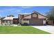 Inviting two-story home with a well-maintained lawn and a spacious two-car garage at 6101 W Grandview Rd, Glendale, AZ 85306