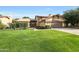 Well-maintained home boasting a lush green lawn, mature landscaping, and a cozy covered patio at 6101 W Grandview Rd, Glendale, AZ 85306
