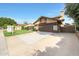 Inviting home with a spacious driveway, manicured lawn, and a charming pergola covered entrance at 6101 W Grandview Rd, Glendale, AZ 85306