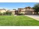 Charming two-story home with well-manicured lawn, mature trees, and a welcoming covered entryway at 6101 W Grandview Rd, Glendale, AZ 85306