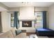 Living room with a prominent fireplace, cozy seating, and ample natural light at 6101 W Grandview Rd, Glendale, AZ 85306