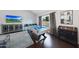 Game room boasts a pool table, TV, and backyard view, enhanced by hardwood floors and natural lighting at 6101 W Grandview Rd, Glendale, AZ 85306