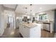 Well-lit kitchen features stainless appliances, white cabinets, and a center island with granite counter at 6101 W Grandview Rd, Glendale, AZ 85306
