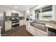 Kitchen with stainless steel appliances, granite counters, white cabinets, and stylish sink at 6101 W Grandview Rd, Glendale, AZ 85306