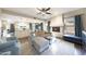 Spacious open-concept living area with fireplace, modern decor, and a view of the kitchen and dining areas at 6101 W Grandview Rd, Glendale, AZ 85306
