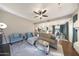 Spacious open-concept living area with modern decor, a ceiling fan, and a view of the kitchen and dining areas at 6101 W Grandview Rd, Glendale, AZ 85306