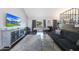 Bright living room featuring a TV, sofa, pool table, and view of the backyard through sliding glass doors at 6101 W Grandview Rd, Glendale, AZ 85306