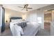 Bedroom with a bed, ceiling fan, and ensuite access to loft at 6101 W Grandview Rd, Glendale, AZ 85306
