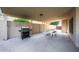 Covered patio with built in grill and outdoor seating perfect for entertaining guests at 6101 W Grandview Rd, Glendale, AZ 85306