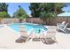 Sparkling pool with Adirondack chairs, perfect for relaxing and enjoying the outdoors at 6101 W Grandview Rd, Glendale, AZ 85306