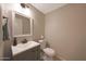 Clean powder room featuring a gray vanity, white countertop, square mirror, and neutral wall paint at 6101 W Grandview Rd, Glendale, AZ 85306