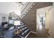 Stylish staircase with a metal railing, hardwood steps and planked wall, leading to the upper level of the home at 6101 W Grandview Rd, Glendale, AZ 85306