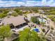 Aerial view of a single-Gathering home, featuring a pool, covered patio, desert landscaping, and mature trees at 6765 E Duane Ln, Scottsdale, AZ 85266