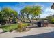 Beautiful backyard features a lush lawn, desert landscaping, and an outdoor grilling area at 6765 E Duane Ln, Scottsdale, AZ 85266