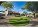 Expansive backyard features a lush lawn, desert landscaping, and a swimming pool with lounge chairs at 6765 E Duane Ln, Scottsdale, AZ 85266