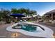Desert oasis showcasing a pool, desert landscaping, mature trees, and comfortable lounge chairs for ultimate relaxation at 6765 E Duane Ln, Scottsdale, AZ 85266