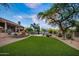 Expansive backyard with green lawn, desert landscaping, mature trees and private pool at 6765 E Duane Ln, Scottsdale, AZ 85266