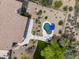 Aerial view of the backyard featuring a pool, patio, desert landscaping and a small lawn at 6765 E Duane Ln, Scottsdale, AZ 85266