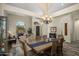 An open concept dining room featuring a chandelier, neutral tones, and wood floors at 6765 E Duane Ln, Scottsdale, AZ 85266