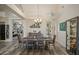 Formal dining room featuring an elegant chandelier, seating for six, and vaulted ceilings at 6765 E Duane Ln, Scottsdale, AZ 85266