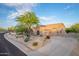 Beautiful home showcasing desert landscaping, a spacious driveway, and a well-maintained exterior at 6765 E Duane Ln, Scottsdale, AZ 85266
