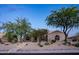 Single story home with mature trees, manicured desert landscaping, and a paver walkway at 6765 E Duane Ln, Scottsdale, AZ 85266