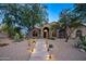 Well maintained home with front yard desert landscaping, paver walkway and mature trees at 6765 E Duane Ln, Scottsdale, AZ 85266