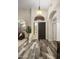 Elegant foyer with high ceilings, decorative lighting, a stylish front door, and beautiful wood floors at 6765 E Duane Ln, Scottsdale, AZ 85266