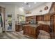 Spacious kitchen features wooden cabinetry, center island cooktop, and outdoor views at 6765 E Duane Ln, Scottsdale, AZ 85266