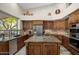 Well-appointed kitchen with stainless steel appliances, granite counters, and center island cooktop at 6765 E Duane Ln, Scottsdale, AZ 85266