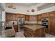 Gourmet kitchen with stainless steel appliances, granite countertops, and central island with cooktop at 6765 E Duane Ln, Scottsdale, AZ 85266