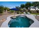 Beautiful pool area with lush desert landscaping, patio umbrella, and comfortable lounge chairs for ultimate relaxation at 6765 E Duane Ln, Scottsdale, AZ 85266