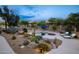 Backyard view of a desert landscaped pool with an umbrella and lounge chairs at 6765 E Duane Ln, Scottsdale, AZ 85266