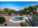 Inviting pool area with desert landscaping, patio umbrella, and lounge chairs offering an ideal outdoor space at 6765 E Duane Ln, Scottsdale, AZ 85266
