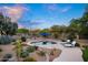Desert landscaped backyard showcasing a pristine pool, lounge chairs, and a vibrant blue umbrella at 6765 E Duane Ln, Scottsdale, AZ 85266