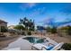 Scenic backyard showcasing a pool, desert landscaping, mature trees, and cozy lounge chairs for relaxation at 6765 E Duane Ln, Scottsdale, AZ 85266