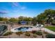 Desert landscaped backyard with pristine pool, lounge chairs, lush cacti and plants, and a vibrant blue umbrella at 6765 E Duane Ln, Scottsdale, AZ 85266