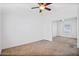 Bright bedroom features a ceiling fan, neutral carpet and mirrored closet doors at 7807 E Main St # F36, Mesa, AZ 85207