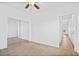 Bedroom with light carpet, ceiling fan, neutral walls and a door to a hallway at 7807 E Main St # F36, Mesa, AZ 85207