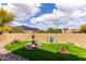 Charming backyard featuring artificial turf, a decorative fountain, and scenic mountain views at 9938 E Little Nugget Way, Gold Canyon, AZ 85118