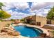 Backyard view with inviting pool and spa, complemented by outdoor seating and desert landscaping, perfect for entertaining at 9938 E Little Nugget Way, Gold Canyon, AZ 85118