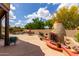 Backyard featuring an outdoor fireplace, lounge seating, and pool with desert landscaping at 9938 E Little Nugget Way, Gold Canyon, AZ 85118